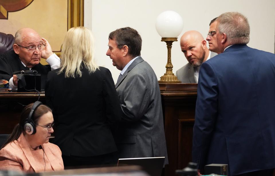 Prosecutors and defense attorneys discuss a point in a sidebar with Pike County Common Pleas Court Judge Randy Deering, Sept. 19, 2022.