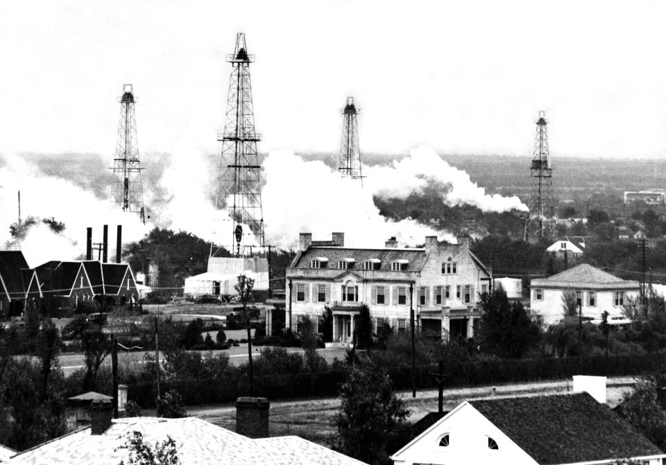 Former Gov. E.W. Marland, who made a fortune in the oil business, helped turn the Capitol area into an oilfield. This photo, with derricks behind the mansion, was taken in October 1935, his first year in office.