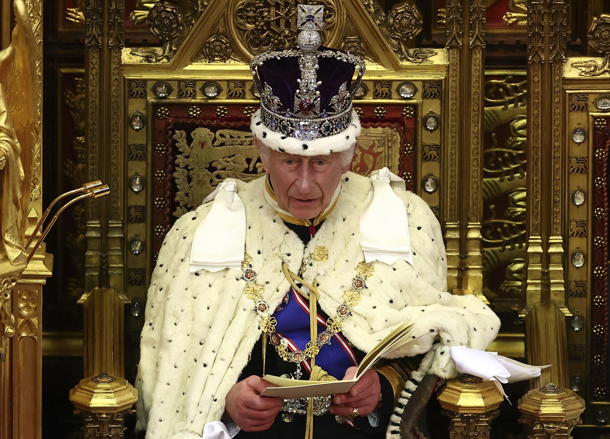 Britain's King Charles III, wearing the Imperial State Crown and the Robe of State, reads the King's Speech from the The Sovereign's Throne in the House of Lords chamber, during the State Opening of Parliament, at the Houses of Parliament, in London, Wednesday, July 17, 2024. (Henry Nicholls/Pool Photo via AP)