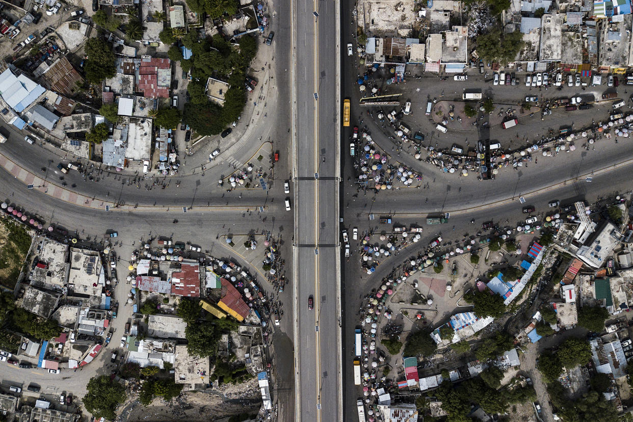 FILE - A normally busy intersection remains free of traffic due to fuel shortages, in Port-au-Prince, Haiti, Oct. 23, 2021. The U.S. government is urging U.S. citizens to leave Haiti given the country’s deepening insecurity and a severe lack of fuel that has affected hospitals, schools and banks. Gas stations remained closed on Thursday, Nov. 11, 2021, a day after the State Department issued its warning. (AP Photo/Matias Delacroix, File)