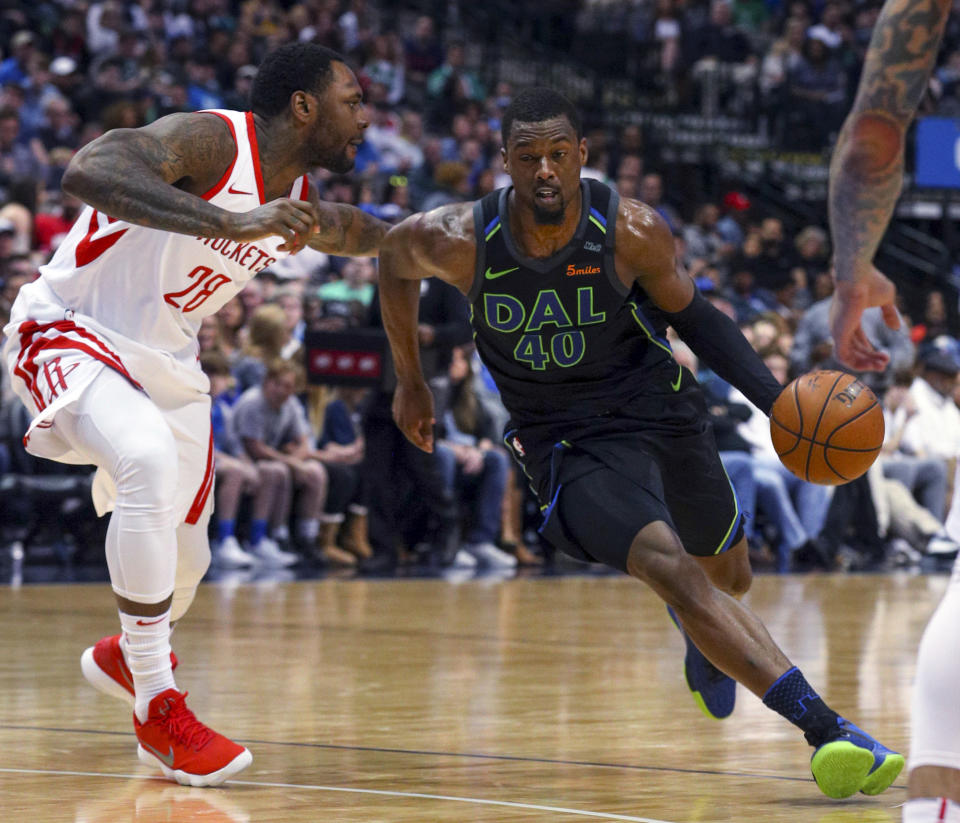 Houston Rockets forward Tarik Black (28) defends as Dallas Mavericks forward Harrison Barnes (40) tries to drive past in thesecond half of an NBA basketball game Sunday, March 11, 2018 in Dallas. (AP Photo/ Richard W. Rodriguez)