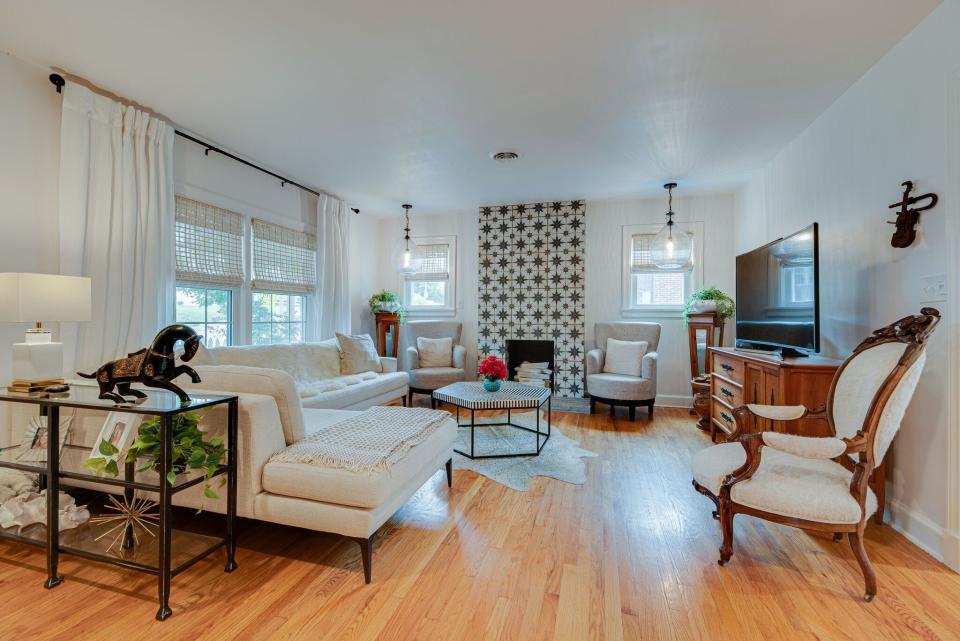 The living room offers lots of natural light and the focal point is the fireplace with geometric Spanish tiles.