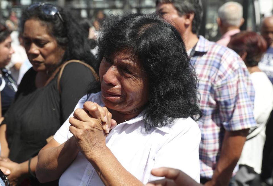 In this April 17, 2019 photo, a supporter of former Peruvian President Alan Garcia grieves after learning that the former leader died from a self-inflicted gun shot, outside the hospital where he was taken after he shot himself, in Lima, Peru. Peru's current President Martinez Vizcarra said Garcia, the 69-year-old former head of state died after undergoing emergency surgery. Garcia shot himself in the head early Wednesday as police came to detain him in connection with a corruption probe. (AP Photo/Martin Mejia)