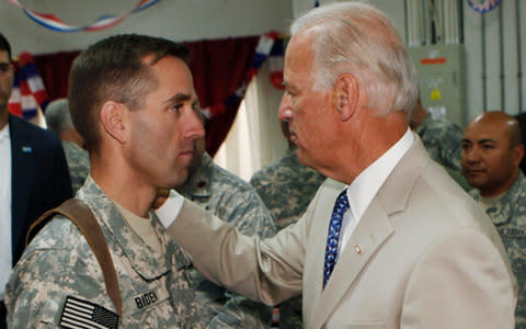 Joe Biden, right, talks with his son Beau Biden, who died in 2015 - Credit: AP Photo/Khalid Mohammed