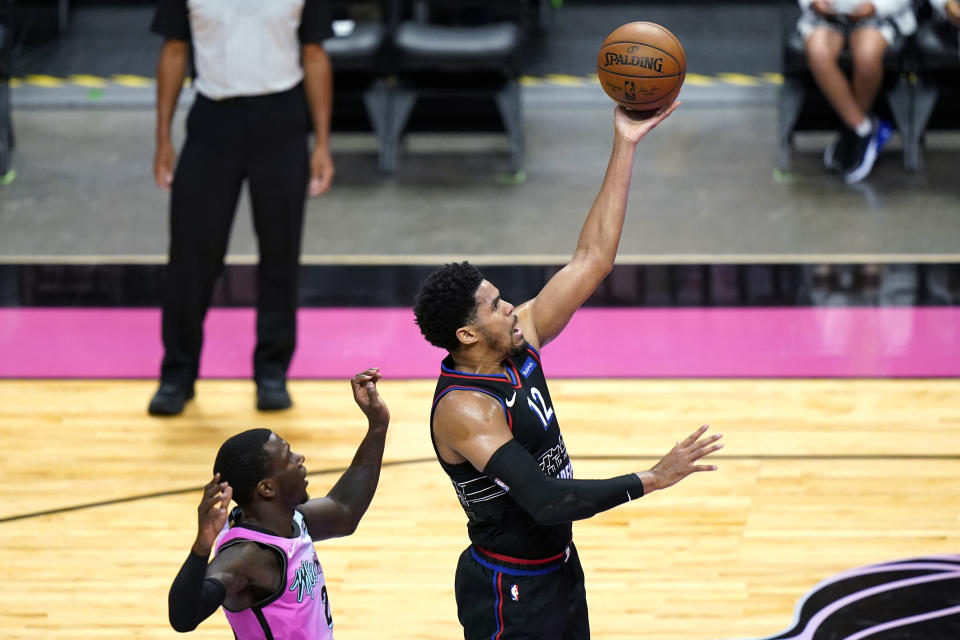 Philadelphia 76ers forward Tobias Harris shoots next to Miami Heat guard Kendrick Nunn during the first half of an NBA basketball game Thursday, May 13, 2021, in Miami. (AP Photo/Lynne Sladky)