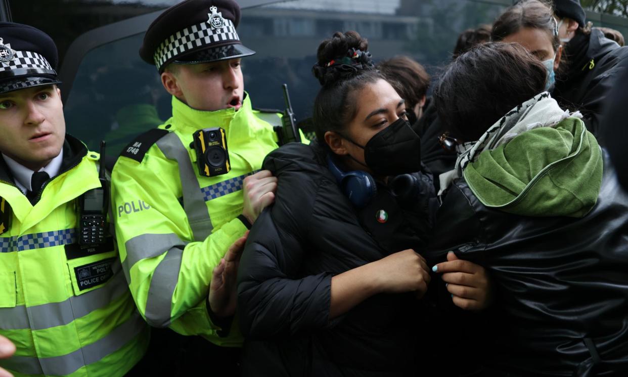 <span>Protesters block a coach taking away asylum seekers from a hotel in Peckham, south-east London. </span><span>Photograph: Andy Hall/The Observer</span>