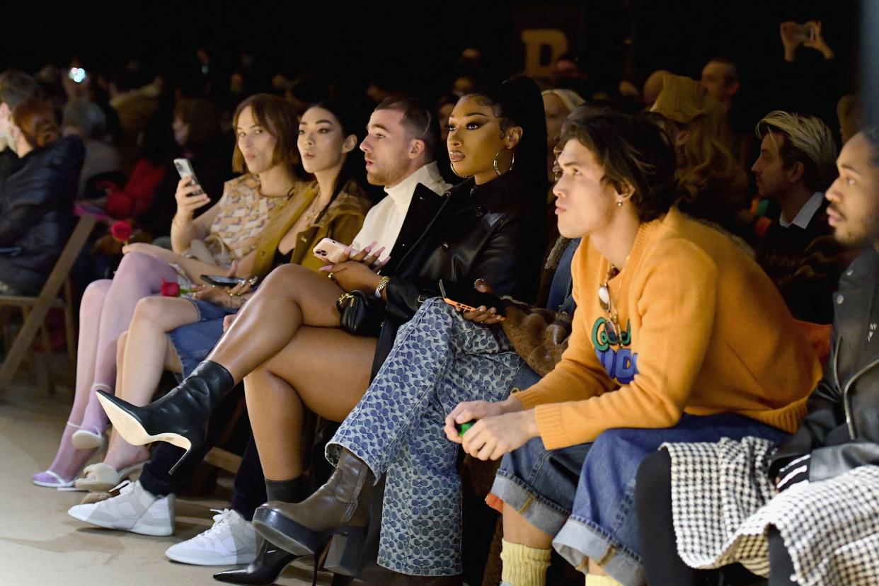 Megan Thee Stallion, Angus Cloud, Rickey Thompson and Charles Melton attend the Coach runway show during New York Fashion Week in New York City on Feb. 14, 2022.