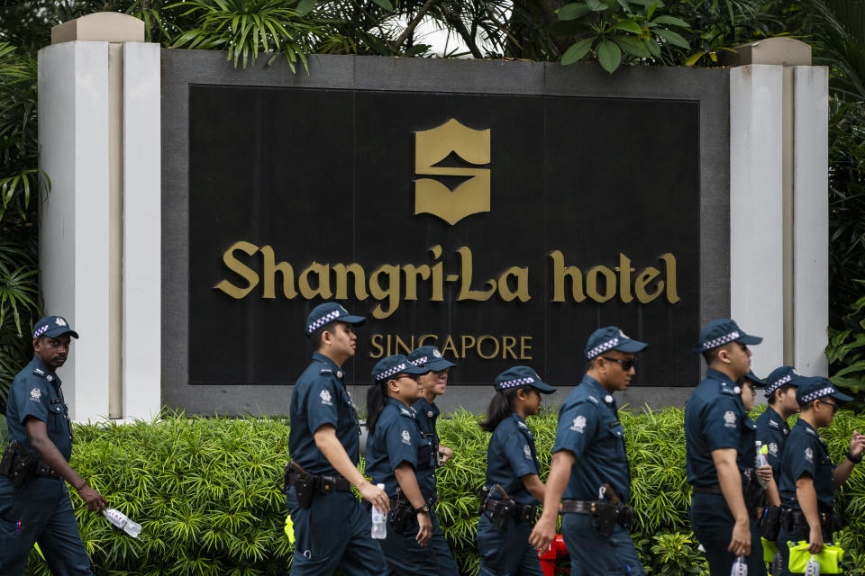 In this June 10, 2018, file photo, police officers patrol outside the Shangri-La Hotel in Singapore ahead of the first summit between U.S. President Donald Trump and North Korean leader Kim Jong Un. Trump and Kim are planning a second summit in the Vietnam capital of Hanoi, Feb. 27-28. (AP Photo/Yong Teck Lim, File)