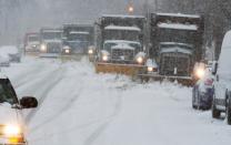 Snowplows clear the snow covered streets on March 5, 2015, in Washington, DC