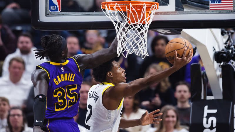 Utah Jazz guard Collin Sexton (2) goes under the hoop for a layup against Los Angeles Lakers forward Wenyen Gabriel (35) during an NBA basketball game between the Utah Jazz and Los Angeles Lakers at Vivint Arena in Salt Lake City on April 4, 2023.