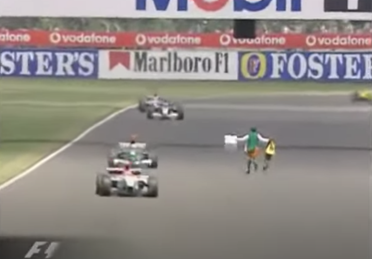 Irish priest Neil Horan runs into the path of F1 cars at the 2003 British Grand Prix (ITV)