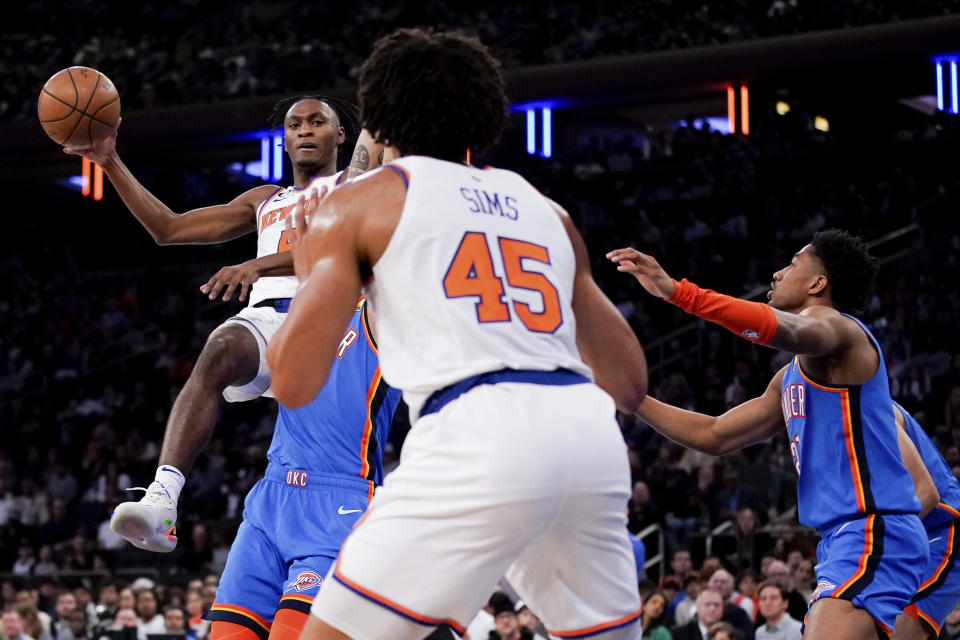 New York Knicks guard Immanuel Quickley passes the ball to center Jericho Sims (45) during the first half of an NBA basketball game against the Oklahoma City Thunder, Sunday, Nov. 13, 2022, in New York. (AP Photo/Julia Nikhinson)