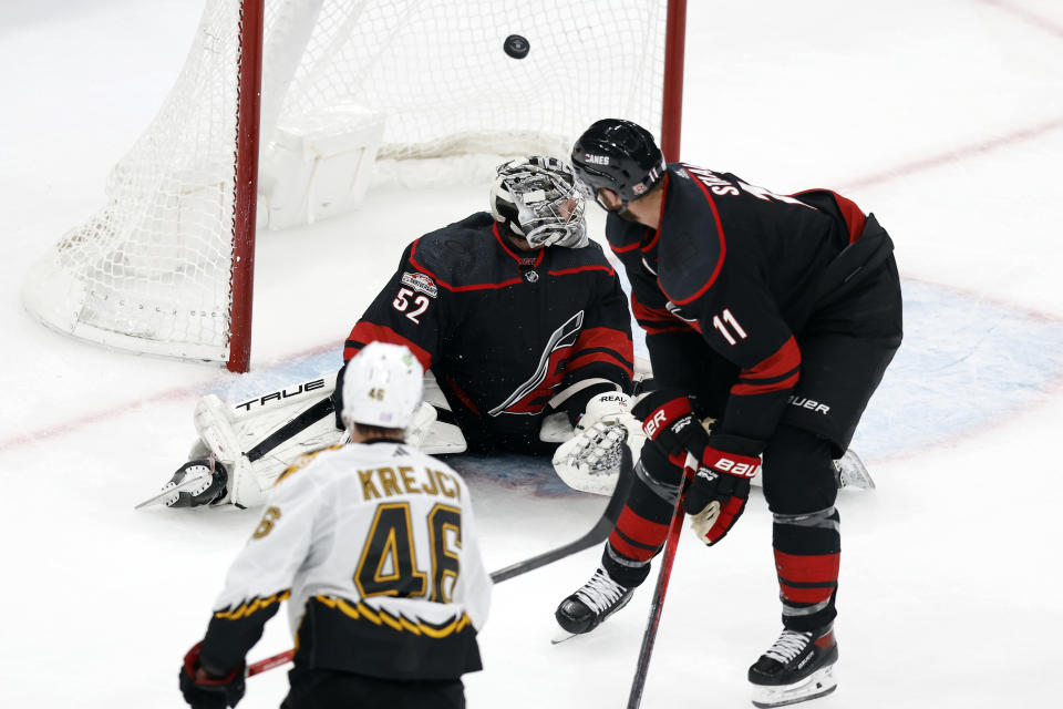 Boston Bruins' David Krejci (46) scores on Carolina Hurricanes' Pyotr Kochetkov (52) during the second period of an NHL hockey game, Friday, Nov. 25, 2022, in Boston. (AP Photo/Michael Dwyer)