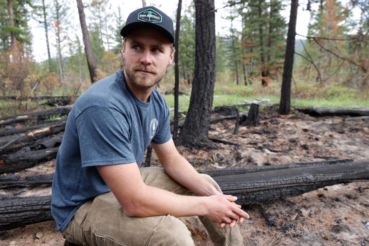 Kenny Forbes, a wildfire rehab specialist, sits on a charred log inside a forest in Kimberly, British Columbia, Canada on Friday, May 31, 2024.
He and others concerned about wildfires took part in a prescribed burn to help burn off fuel like twigs, logs and dried pine needles to help prevent wildfires here.