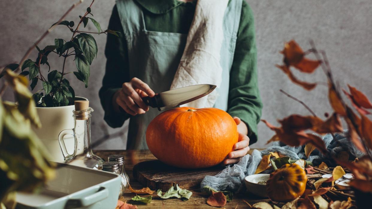  A woman carving a pumpkin 