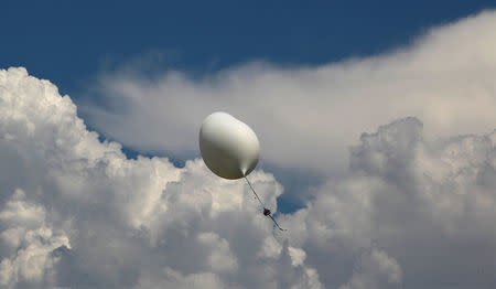 A balloon carries cameras and other equipment that will be used to monitor the coming solar eclipse during a test launch with students and faculty with the College of Charleston for the Space Grant Ballooning Project on board a US Coast Guard response boat at sea near Charleston, South Carolina, U.S. August 17, 2017. Location coordinates for this image are 32º41' 975" N 79º44'195" W. REUTERS/Randall Hill