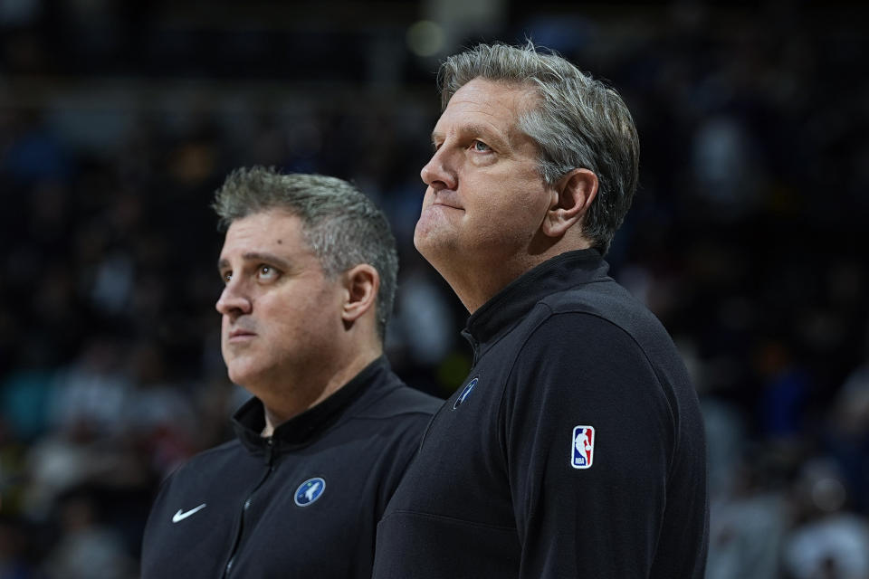 FILE - Minnesota Timberwolves head coach Chris Finch, right, and assistant coach Micah Nori watch in the first half of an NBA basketball game Friday, March 29, 2024, in Denver. The Timberwolves have two All-Stars in their lineup and the best defense in the NBA, but they likely wouldn't have secured the second-most wins in franchise history without a behind-the-scenes boost from a coaching staff led by Chris Finch that has forged a strong sense of camaraderie with each other and a clear level of trust with the players. (AP Photo/David Zalubowski, File)