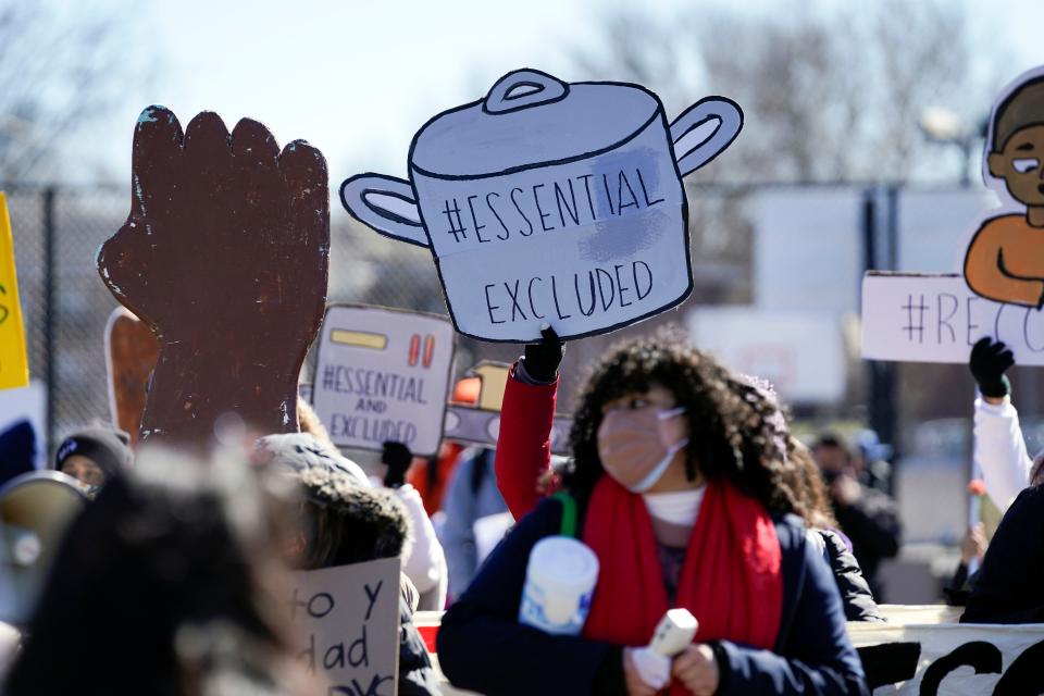 Domestic workers and immigrant women march Sunday in Passaic, N.J., to mark the one-year anniversary of the coronavirus pandemic and to call on New Jersey Gov. Phil Murphy and the Legislature to provide aid to the state's half-million undocumented immigrants and their families.