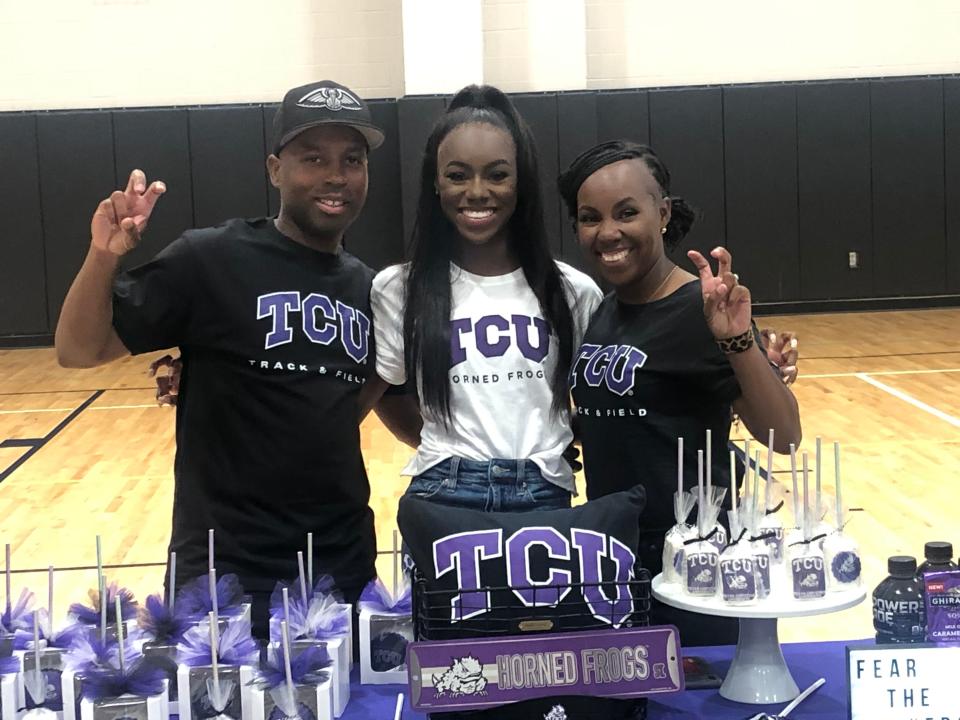 Central Lafourche track athlete Ke'Yona Gabriel (middle) poses for a photo with her stepfather Mark Smith (left) and her mother April Smith after signing with TCU in Lockport on April 28.