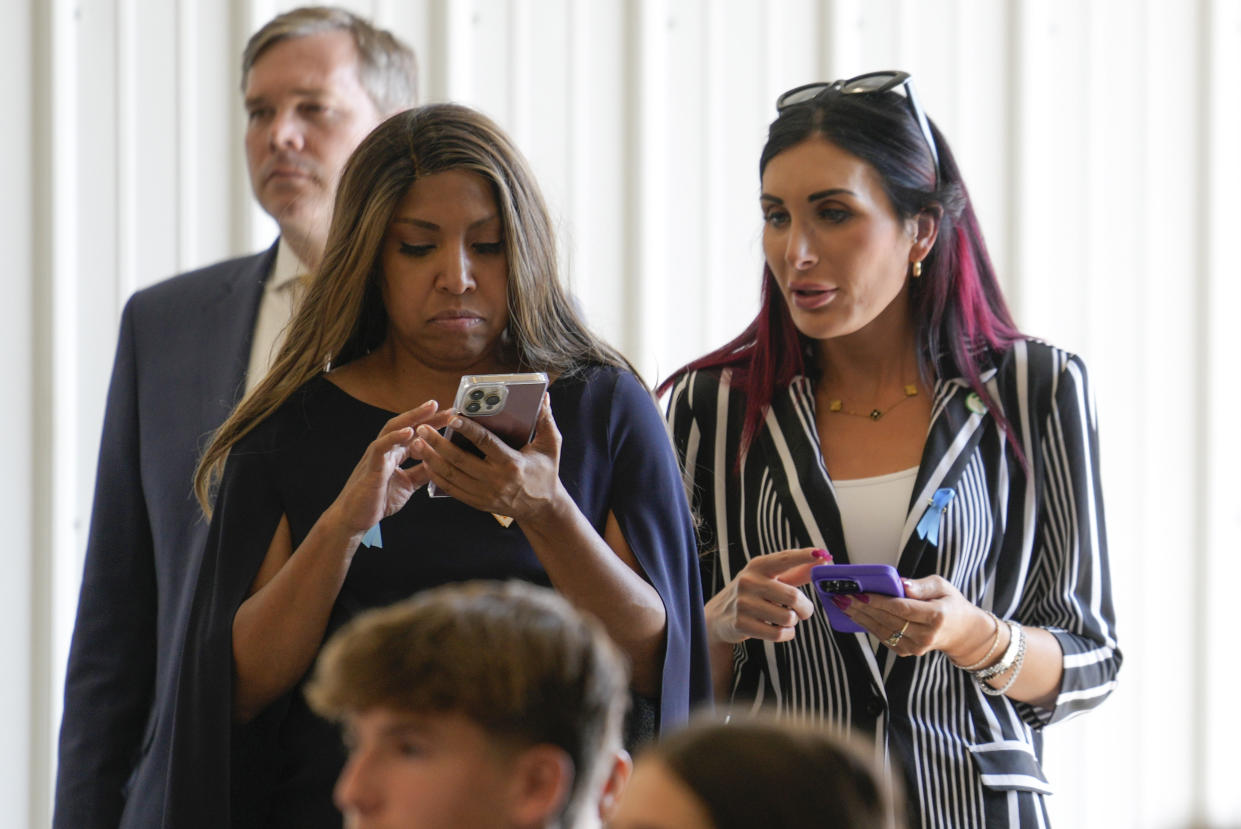 Laura Loomer, right, alongside Lynne Patton, watches as former President Donald Trump visits the Shanksville Volunteer Fire Company in Shanksville, Pa., on Sept. 11. 