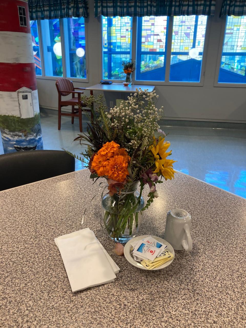 Flower donations to the Caribou Memorial Veterans Pavillion are laid on the tables for residents to enjoy.