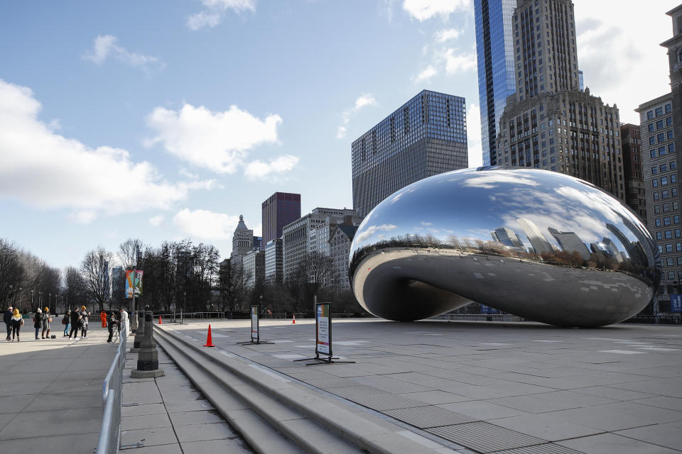 People visit a closed off Cloud Gate statue, known as the “Bean”, in Millennium Park in Chicago (Getty)