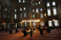 People sit in a mosque in Istanbul, Wednesday, Aug. 15, 2018. The Turkish lira currency has nosedived in value in the past week over concerns about Turkey's President Recep Tayyip Erdogan's economic policies and after the United States slapped sanctions on Turkey angered by the continued detention of an American pastor. (AP Photo/Lefteris Pitarakis)