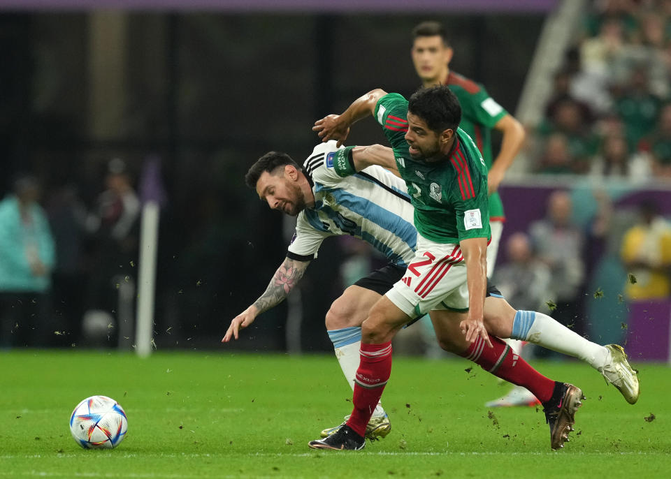 Argentina's Lionel Messi (left) and Mexico's Nestor Araujo battle for the ball during the FIFA World Cup Group C match at the Lusail Stadium in Lusail, Qatar. Picture date: Saturday November 26, 2022. (Photo by Martin Rickett/PA Images via Getty Images)