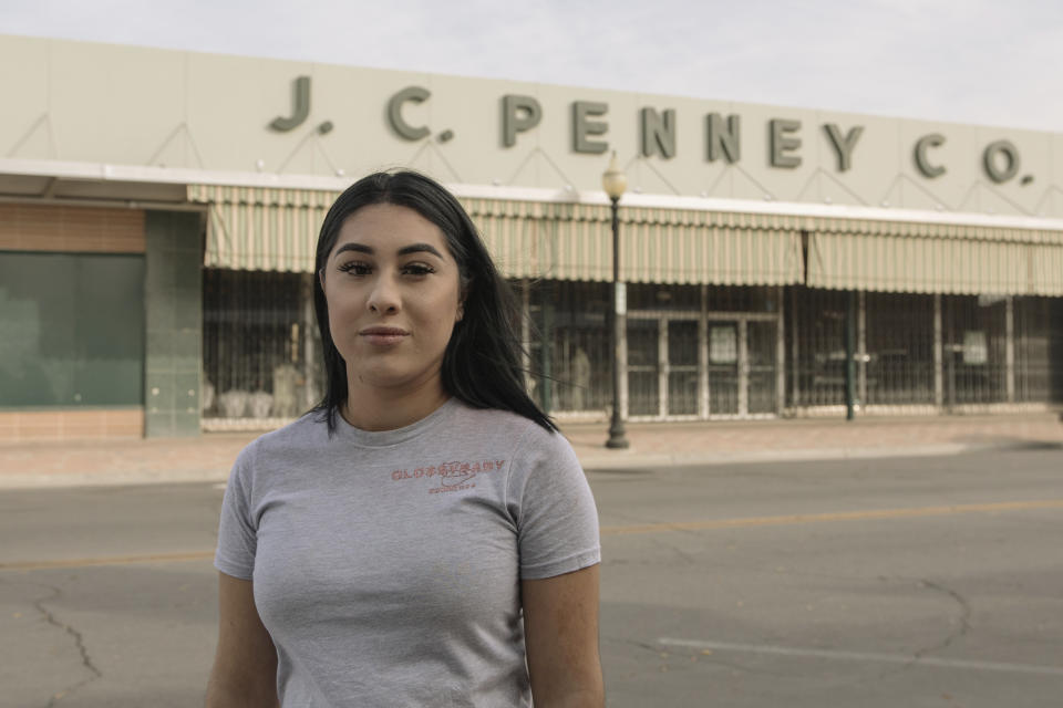 Alexandra Orozco stands for a portrait outside of the closed J.C. Penney where she was laid off from, in Delano, Calif., on Sunday, Dec. 6, 2020. Orozco began working part-time at the department store when she was 18, and in nearly four years rose through the ranks from cashier to freight team associate. (Madeline Tolle/The Fuller Project via AP)