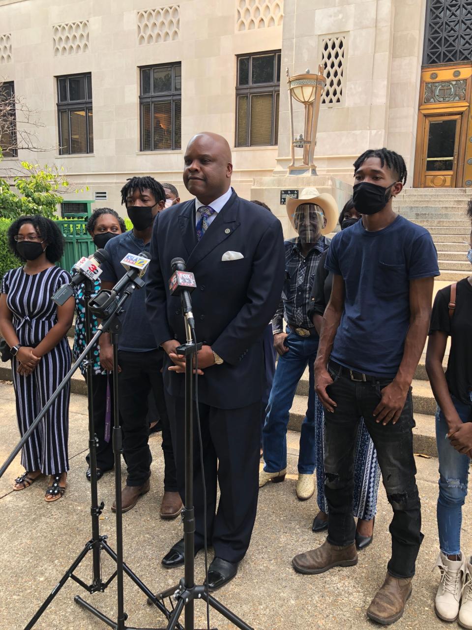 Attorney James Carter, surrounded by the family of Tommie McGlothen Jr., takes questions during a press conference on Friday.  Four Shreveport police officers have been indicted on charges of negligent homicide and malfeasance.