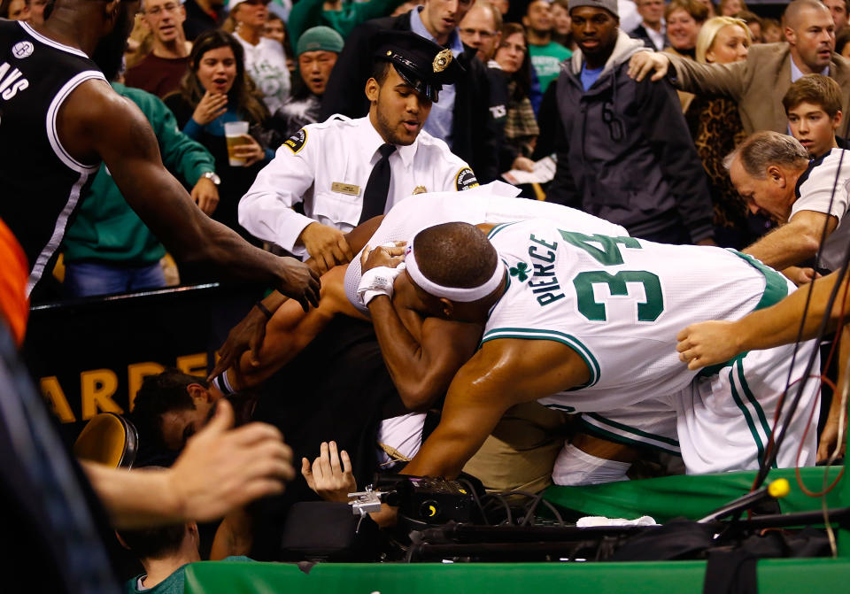 BOSTON, MA - NOVEMBER 28: Paul Pierce #34 and Rajon Rondo #9 of the Boston Celtics fight with Kris Humphries #43 of the Brooklyn Nets while security and referees attempt to break it up behind the basket after Humphries fouled Kevin Garnett #5 of the Boston Celtics during the game on November 28, 2012 at TD Garden in Boston, Massachusetts. Kris Humphries and Rajon Rondo would be immediately ejected from the game. NOTE TO USER: User expressly acknowledges and agrees that, by downloading and or using this photograph, User is consenting to the terms and conditions of the Getty Images License Agreement. (Photo by Jared Wickerham/Getty Images)