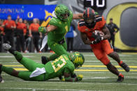 Oregon State running back B.J. Baylor (4) runs past Oregon linebacker Noah Sewell (1) and safety Jeffrey Bassa (33) during the first quarter of an NCAA college football game Saturday, Nov. 27, 2021, in Eugene, Ore. (AP Photo/Andy Nelson)