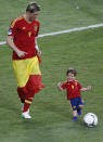 Spain's Fernando Torres (L) plays a ball with his son Leo after defeating Italy to win the Euro 2012 final soccer match at the Olympic stadium in Kiev, July 1, 2012. REUTERS/Charles Platiau (UKRAINE - Tags: SPORT SOCCER TPX IMAGES OF THE DAY)