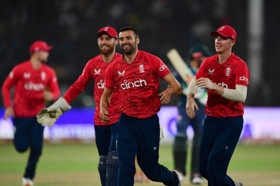 Mark Wood (centre) celebrates after taking the wicket of Pakistan’s captain Babar Azam  (AFP via Getty)