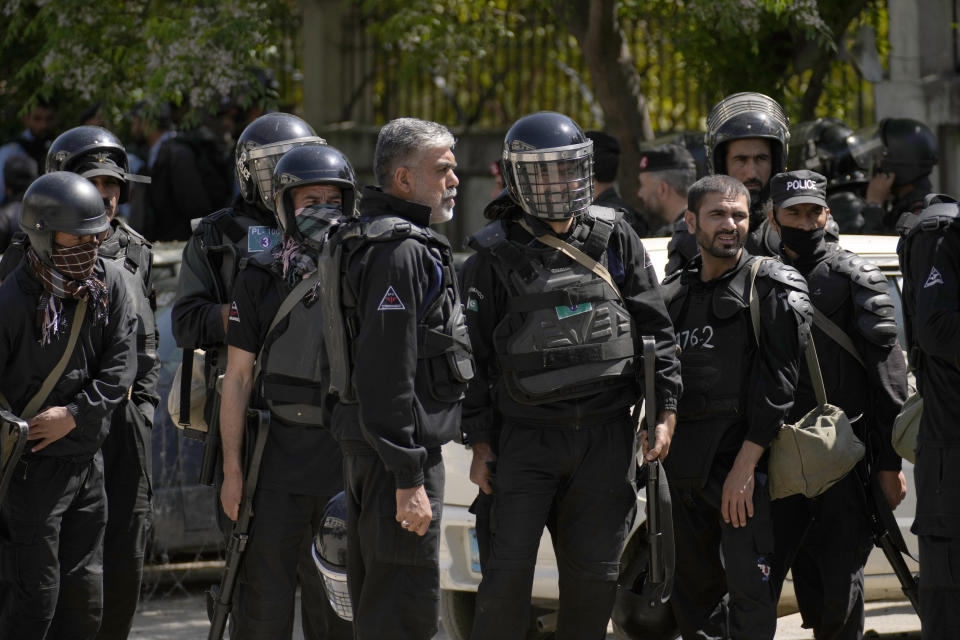 Riot police officers stand guard outside a court where former Prime Minister Imran Khan appeared for his case, in Islamabad, Pakistan, Monday, March 27, 2023. A Pakistani court ruled in defense of former Prime Minister Khan, granting him protection from arrest as lawsuits mounted against the ousted premier, with police charging him with incitement to violence in several cases when his followers clashed with the security forces this month. (AP Photo/Anjum Naveed)