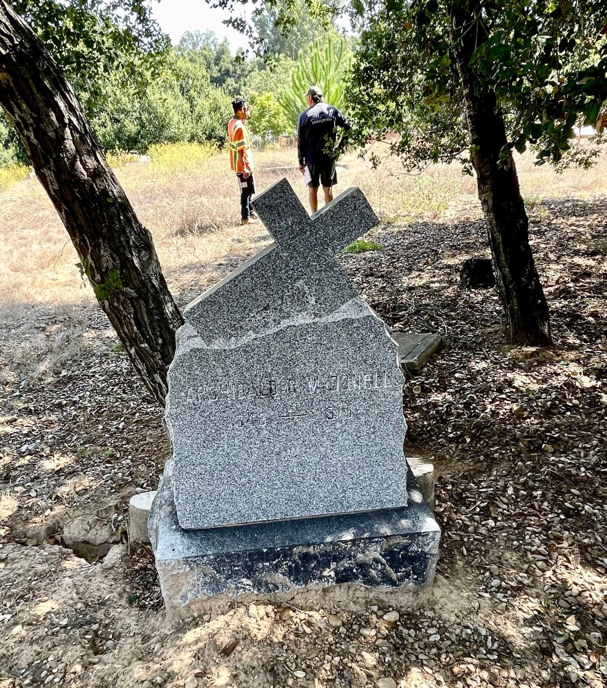 Michael Chapman, right, talks to a construction worker at St. Thomas Aquinas Cemetery in the Ojai Valley on Sept. 8th. A month after work on a restoration project stopped due to community concerns, workers have started sifting through soil before the project resumes.