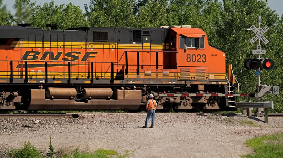 A freight train moves through a crossing