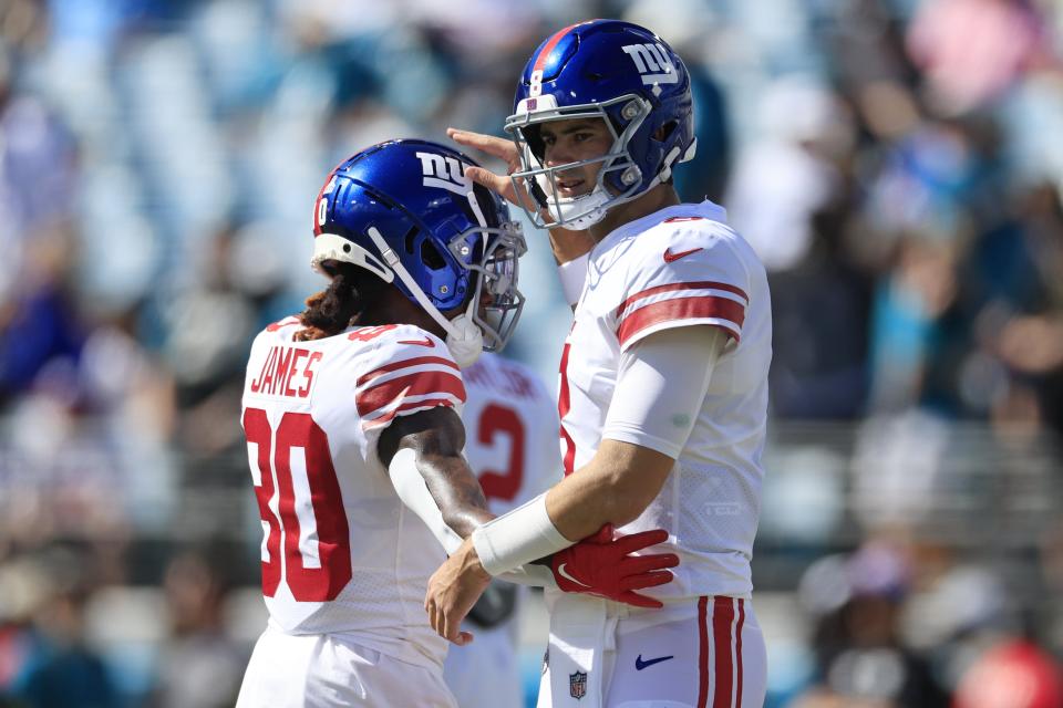 New York Giants quarterback Daniel Jones (8) greets teammate wide receiver Richie James (80) before of a regular season NFL football matchup Sunday, Oct. 23, 2022 at TIAA Bank Field in Jacksonville. [Corey Perrine/Florida Times-Union]