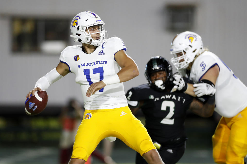 While under pressure from the Hawaii defense, San Jose State quarterback Nick Starkel (17) throws an interception during the second half of an NCAA college football game, Saturday, Sept. 18, 2021, in Honolulu. (AP Photo/Marco Garcia)