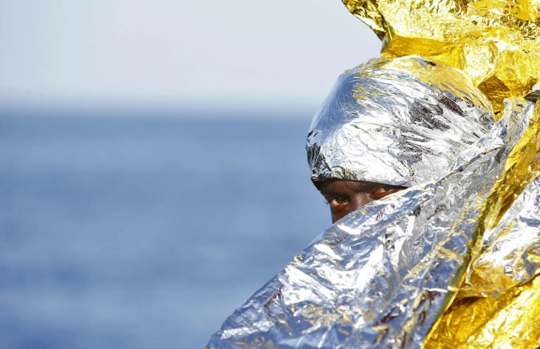 A migrant is wrapped in a survival foil blanket after landing in Vibo Marina, southern Italy, following a rescue operation in the Mediterranean Sea