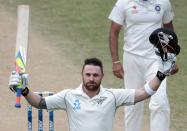 New Zealand's Brendon McCullum acknowledges his 300 next to India's Zaheer Khan during the second innings of play on day five of the second international test cricket match at the Basin Reserve in Wellington, February 18, 2014. McCullum made the highest score ever for a New Zealander with 302.