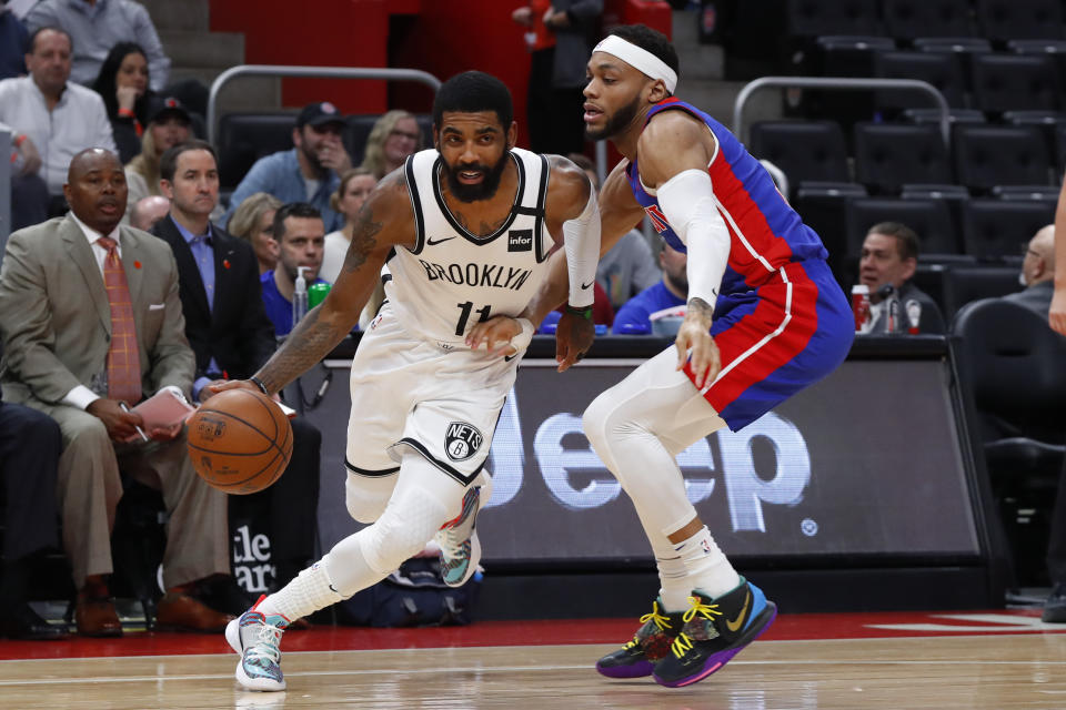 Brooklyn Nets guard Kyrie Irving (11) drives against Detroit Pistons guard Bruce Brown (6) in the first half of an NBA basketball game in Detroit, Saturday, Jan. 25, 2020. (AP Photo/Paul Sancya)