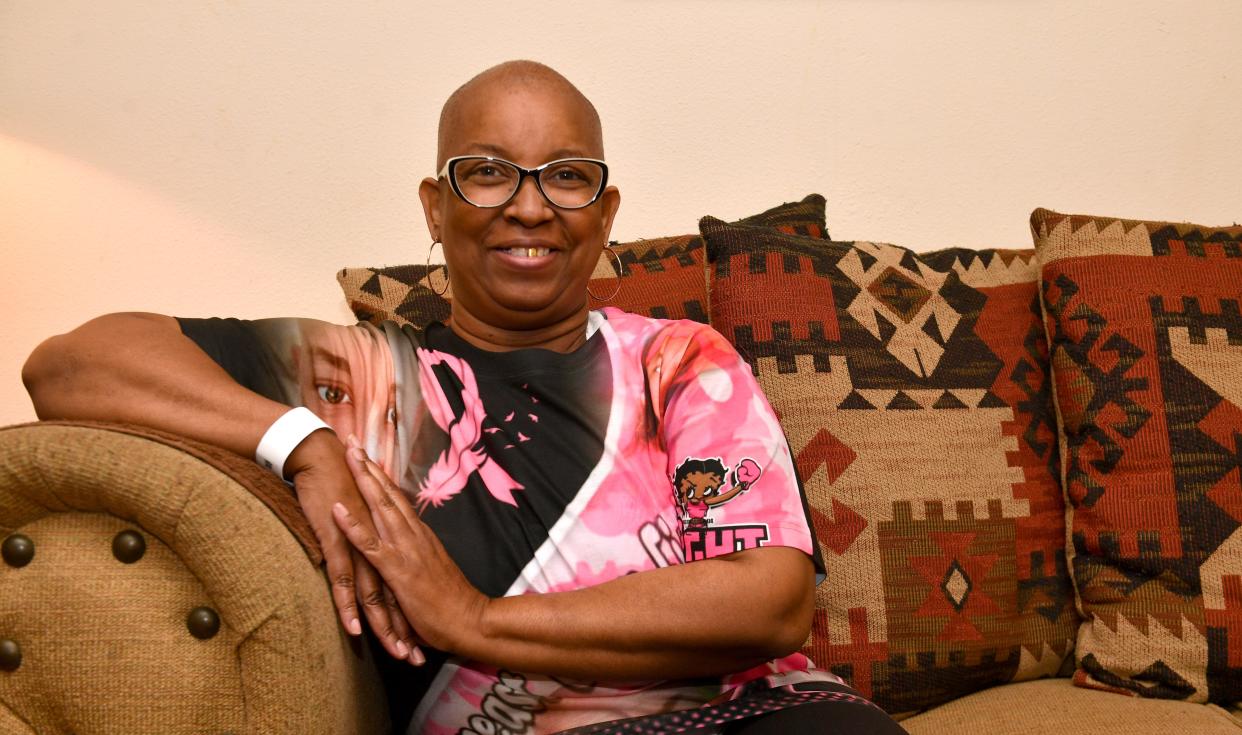 Tina Davis wears a t-shirt, a gift from a niece, recognizing Breast Cancer Awareness Month and honoring her own fight with the disease.