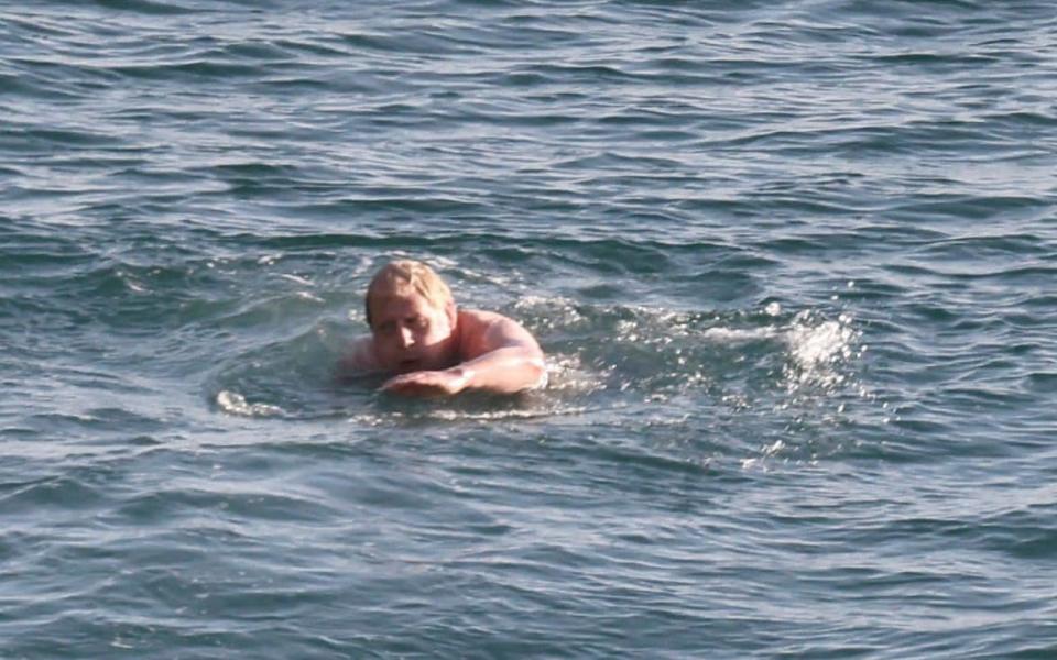 Boris Johnson goes for a morning swim on Saturday before the start of his G7 meetings - AFP