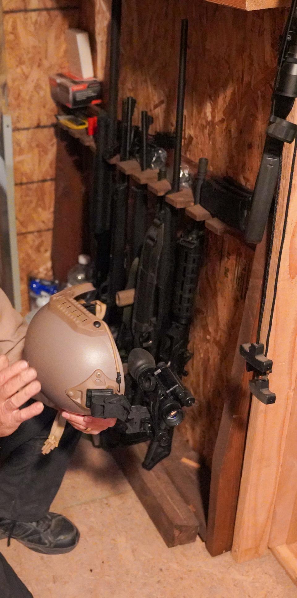 Drew Miller, a retired U.S. Air Force colonel, shows off a ballistic helmet and firearms at the southern Colorado location of Fortitude Ranch emergency preparedness or "prepper" community, which has multiple emergency shelters into which members can retreat during a societal collapse.