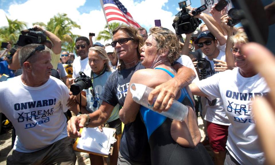 Diana Nyad and her trainer Bonnie Stoll hug as Nyad walks ashore in Florida after her 2013 swim