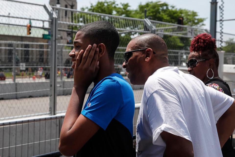 Nicholas Waller, 15, watches Trans Am cars practice with his father Tony White, both of Detroit, during the Free Prix Day of the Detroit Grand Prix in Detroit on Friday, June 2, 2023.