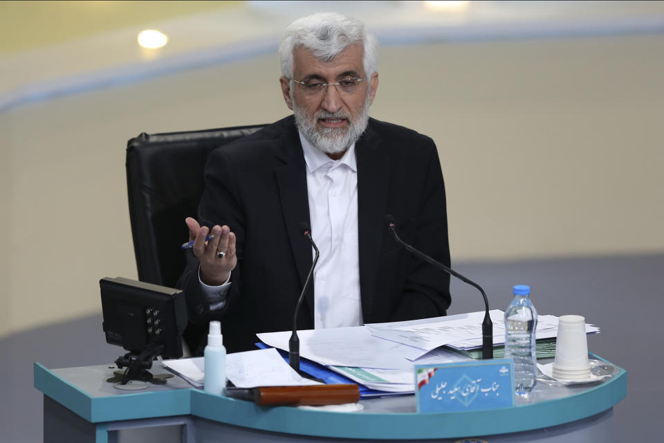 In this photo made available by the government-affiliated Young Journalists Club, presidential candidate Saeed Jalili speaks in a televised debate in a state-run television studio, in Tehran, Iran, on Saturday, June 5, 2021. Elections are scheduled for June 18. (Morteza Fakhri Nezhad/YJC via AP)