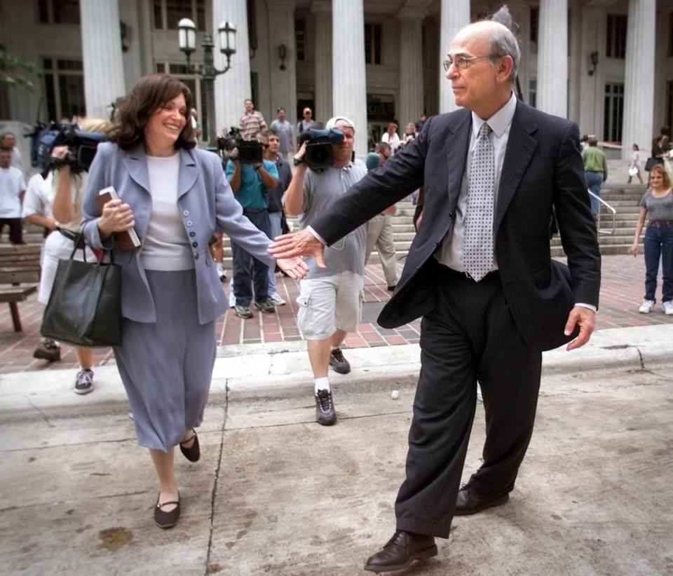 Stanley Rosenblatt helps his wife Susan cross Flagler Street as they leave the courthouse after the big tobacco verdict on July 14, 2000.