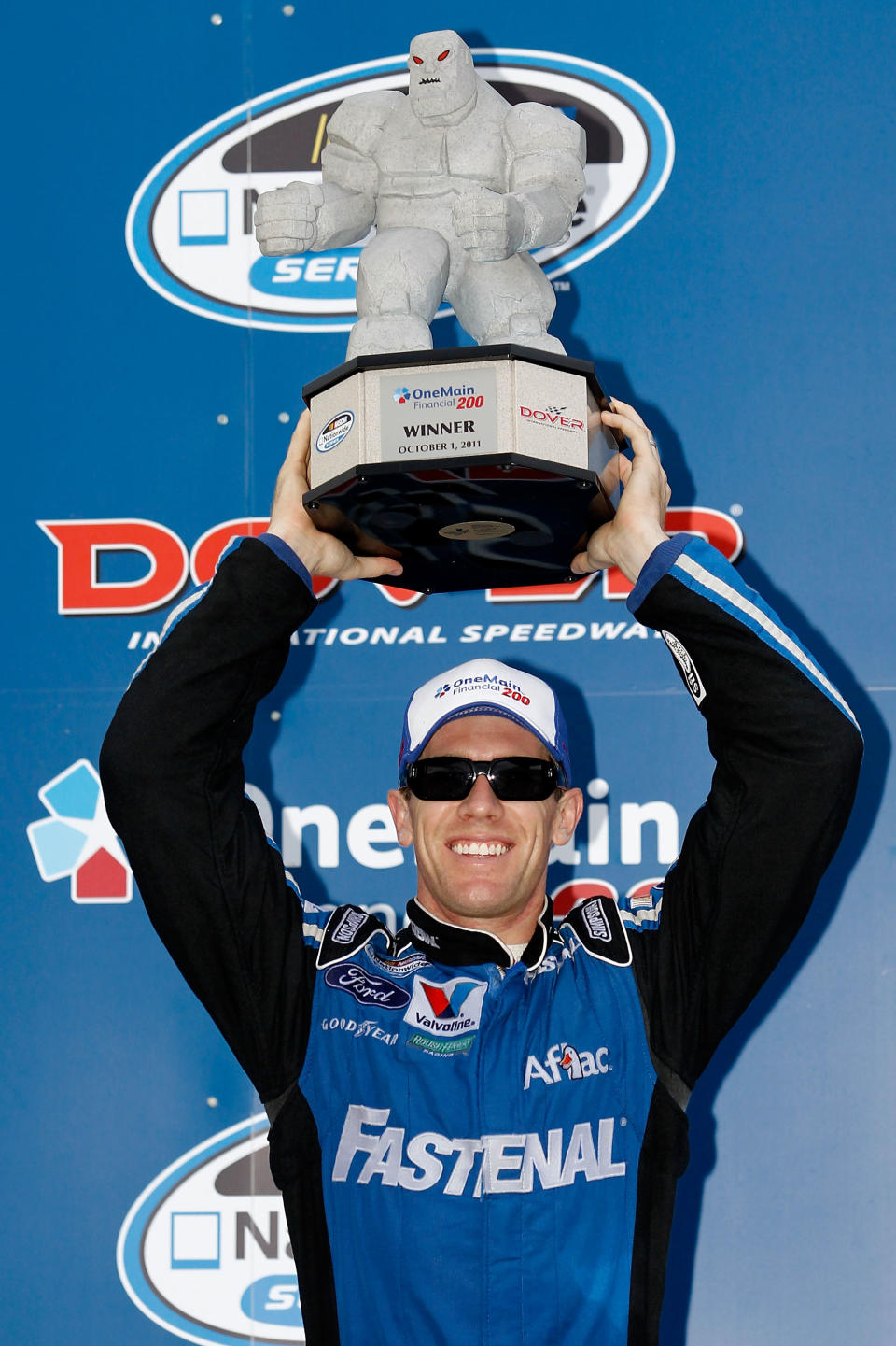 DOVER, DE - OCTOBER 01: Carl Edwards, driver of the #60 Fastenal Ford, celebrates with the trophy in victory lane after he won the NASCAR Nationwide Series OneMain Financial 200 at Dover International Speedway on October 1, 2011 in Dover, Delaware. (Photo by Todd Warshaw/Getty Images for NASCAR)